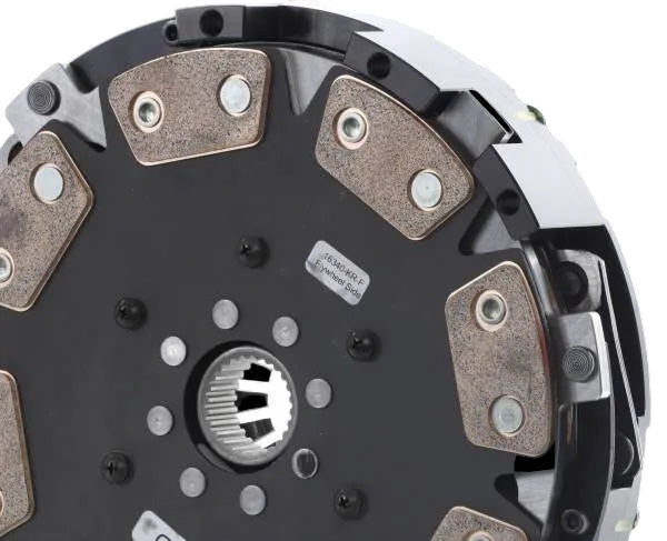 Clutch plate with metallic friction material on a black background